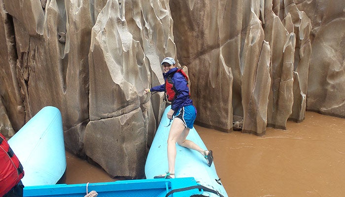 Hualapai-rafting-Tori-FlutedRocks_LukaMontana_700 Editor Tori Peglar reaches out to touch fluted rocks on the edge of the Colorado River. Photo by Luka Montana